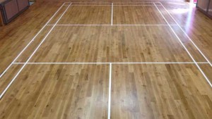 Absolute Floorcare sand and seal wooden floors and redo sports courts markings